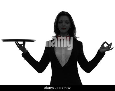 one  woman waiter butler holding empty tray zen gesturing in silhouette on white background Stock Photo