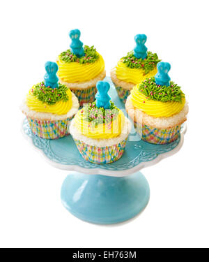 Easter cupcake. Angel food cupcake with vanilla frosting decorated with a candy bunny, isolated on white background. Stock Photo
