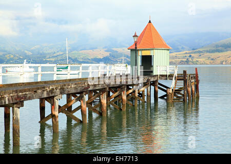 motor boat jetty pier building on lake at Akaroa New Zealand Stock Photo