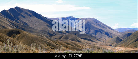 Panorama of Dry Mountain Range Landscape at Lindis Pass, the highest highway, in NewZealand Stock Photo