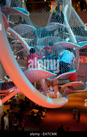 Infinity Climber a suspended multi-story play space for children and adults hanging over Atrium floor of Liberty Science Center Stock Photo