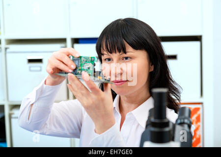 Woman making a micro processor Stock Photo