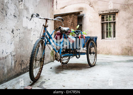 Delivery trikes service narrow lanes in old section of Guangzhou, China Stock Photo