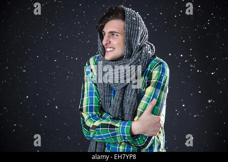 Happy man standing with snow on background Stock Photo