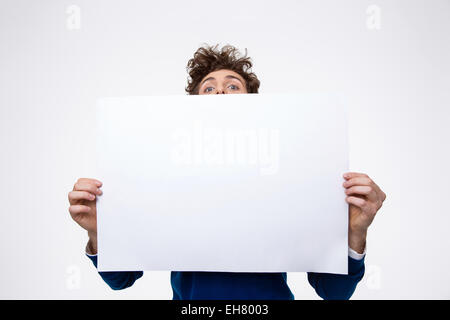 Man holding blank paper and looking at camera Stock Photo