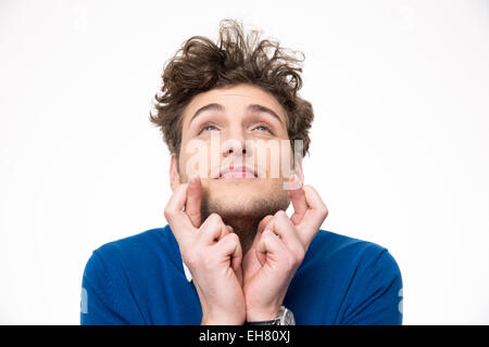 Young handsome man with crossed fingers over white background Stock Photo