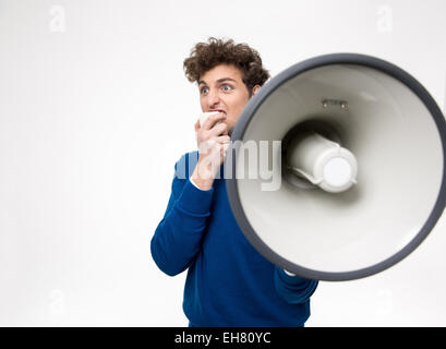 Man shouting through megaphone over gray background Stock Photo