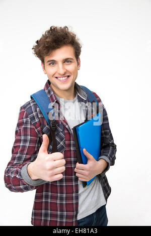 Happy male student with backpack and folders showing thumb up Stock Photo