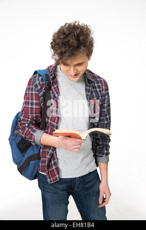 Portrait of a handsome man reading book over gray background Stock Photo