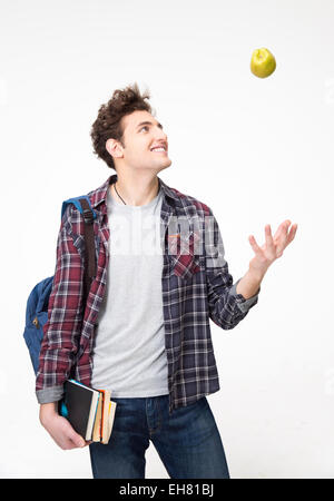 Portrait of a young man with book and an apple Stock Photo