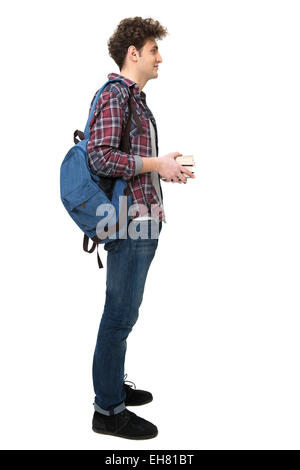 a side view portrait of a smiling student carrying his backpack ...