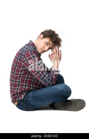 Side view portrait of a young man sitting on the floor Stock Photo