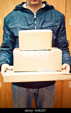 man from a parcels firm delivering packages Stock Photo