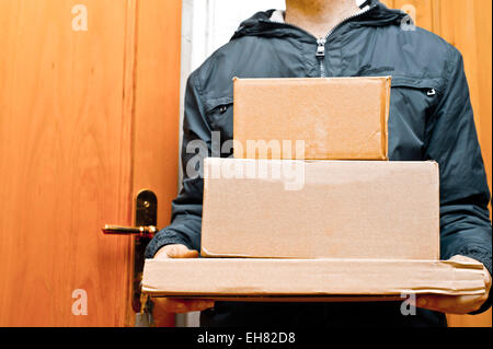 man from a parcels firm delivering packages Stock Photo