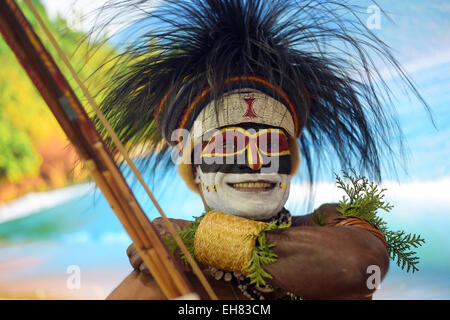 Berlin, Germany. 07th Mar, 2015. A man from Papua New Guinea wearing a traditional headgear and face paint stands at the country's exhibition booth during the ITB international tourism fair in Berlin, Germany, 07 March 2015. The International Tourism Fair ITB is open to visitors until 08 March 2015. Photo: Rainer Jensen/dpa/Alamy Live News Stock Photo