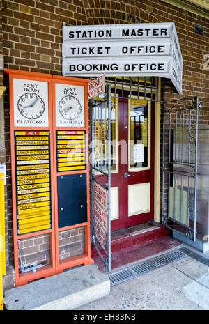 Old fashioned station displays and signage; station departures board; railway departure times; station ticket office; booking office; station master Stock Photo