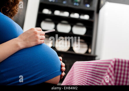 Pregnant woman with cigarette in her hand. Stock Photo