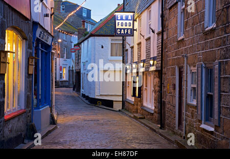 A narrow street in St Ives, Cornwall, at dusk, England UK Stock Photo