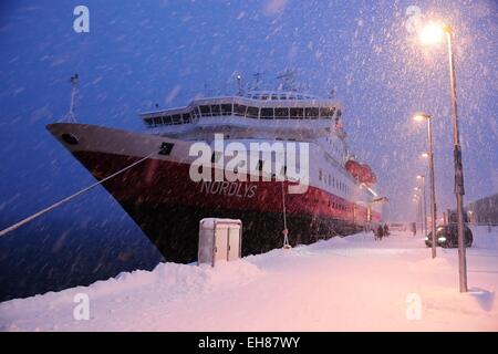 Hurtigruten ship Norlys in snow drifting, docked in the port of Tromso, Troms, Norway Stock Photo