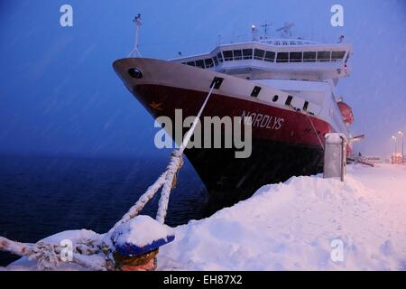 Hurtigruten ship Norlys in snow drifting, docked in the port of Tromso, Troms, Norway Stock Photo