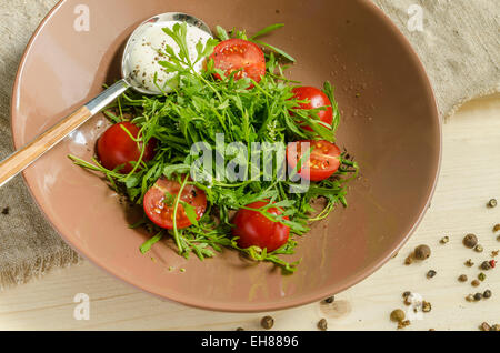 Watercress salad with cherry tomatoes and sour cream. From series Natural organic food Stock Photo