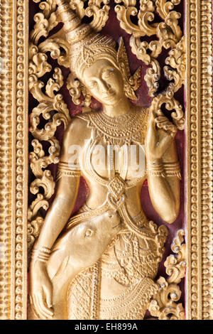 Religious carvings on the doors of Wat Xieng Thong, Luang Prabang, Laos. Stock Photo