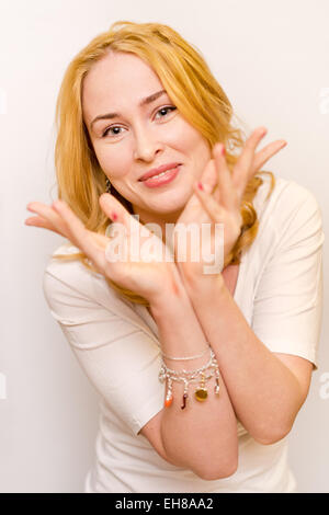 portrait of young redheaded caucasian ginger girl holding her arms near the face Stock Photo