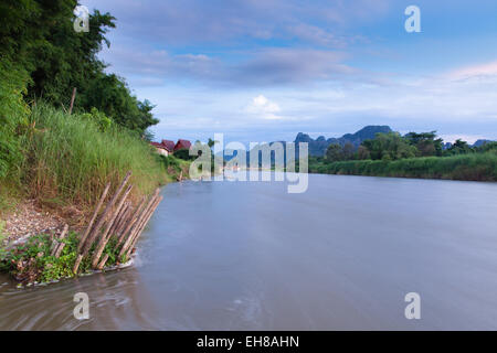 Vang Vieng village after sunset, popular tourist resort in Laos Stock Photo