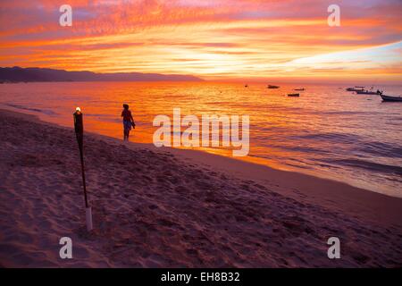 Torch and couple on the beach in Downtown at sunset, Puerto Vallarta, Jalisco, Mexico, North America Stock Photo