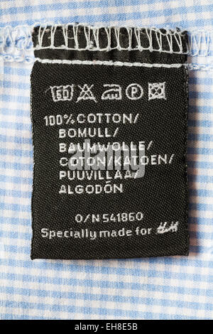 100% cotton label in checked shirt clothing Specially made for H&M - care washing symbols and instructions Stock Photo