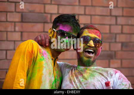 Dhaka, Bangladesh, 08 March 2015.Bangladeshi youth playing coloured powders during Holi celebrations at the Fine Arts Institute of Dhaka University. The Holi festival is celebrated to mark the onset of spring, with people from all walks of life coming out on the streets and applying coloured powder to anyone and everyone upon the advent of spring. Holi is the festival of colors, fun and frolic and is celebrated by millions of Hindus in the Indian subcontinent to welcome the spring. An ancient Hindu festival, Holi is marked as a triumph of good over evil, and has become popular among non-Hindu  Stock Photo