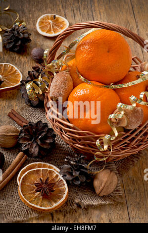 Tangerines in a basket on a wooden background Stock Photo
