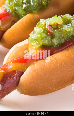 Sweet relish on grilled hot dog. Mustard and ketchup. Stock Photo