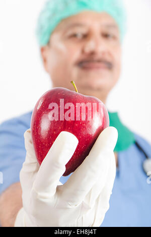1 indian Senior Adult Man Surgeon doctor Apple Showing Stock Photo