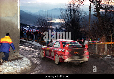 Tommi Makinen driving his Mitsubishi Lancer Evo VI on a stage of the 1999 Monte Carlo Rally Stock Photo