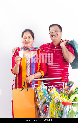 2 indian Seniors  Married couples trolley Credit Card online Shopping Stock Photo