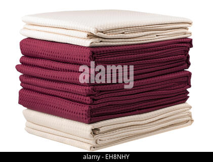 Pile of dark red and cream folded lined curtains Stock Photo