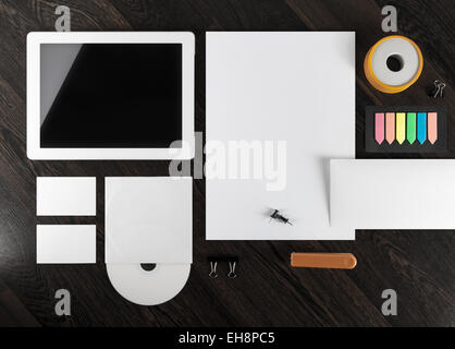 Corporate identity template on dark wooden background. Top view. Stock Photo