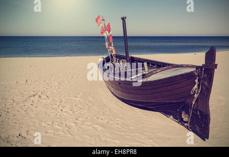 Retro filtered picture of fishing boat on the beach Stock Photo - Alamy