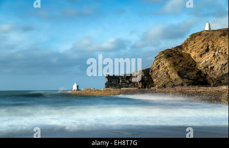 A long exposure of the harbour at Portreath in Cornwall, the white building on the pier is known as the Monkey Hut and the one o Stock Photo