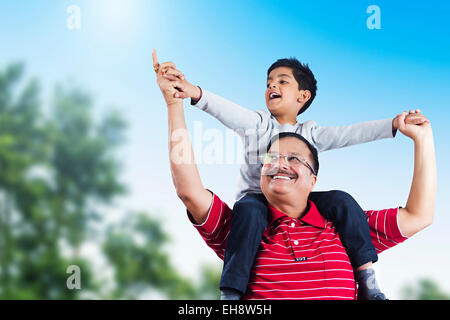 2 indian grand father and Grand son Carrying On Shoulders park enjoy Stock Photo