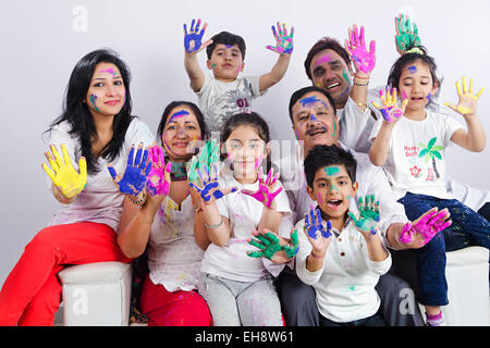 indian group crowds grand Parents Joint Family holi Festival sitting Sofa hand showing Stock Photo