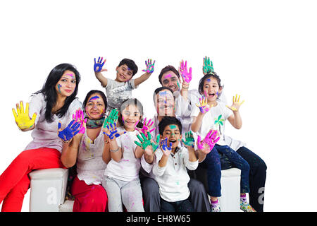 indian group crowds grand Parents Joint Family holi Festival sitting Sofa hand showing Stock Photo