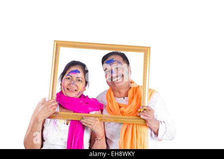 2 indian Seniors Married couples holi Festival picture Frame showing Stock Photo