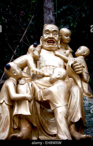 Buddha with children Ten Thousand Buddhas Monastery - Man Fat Tsz - a Buddhist temple in Sha Tin, Hong Kong Stock Photo