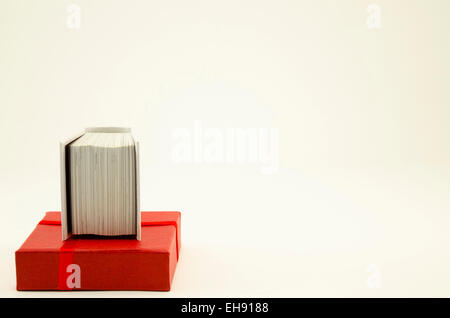 Red box lid and a small book on white Stock Photo