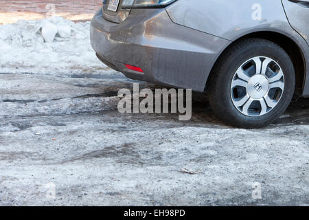 Car driving on snow packed road - USA Stock Photo