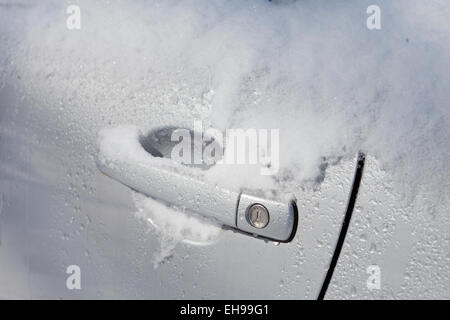 Snow on car door handle - Virginia USA Stock Photo