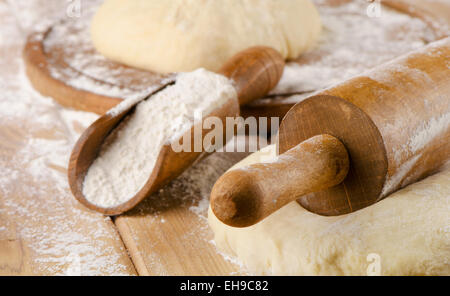 Dough with rolling pin on a wooden table. Selective focus Stock Photo