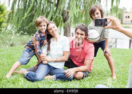 Using digital camera to photograph family with two children, personal perspective Stock Photo